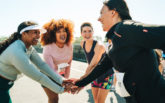Group of diverse female runners bonding before a race