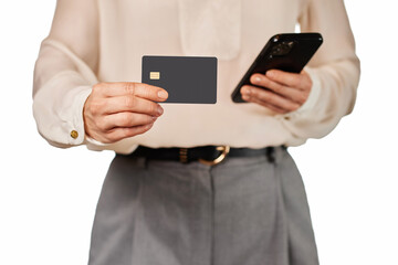 businesswoman in white shirt holding mobile phone and black premium credit bank card on white background. Online shopping.