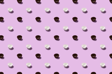 Brown and white paper cups for cake on purple isolated background.
