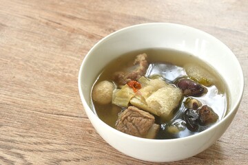 boiled bamboo mushroom with pork bone and black ear mushroom in clear Chinese herb soup on bowl