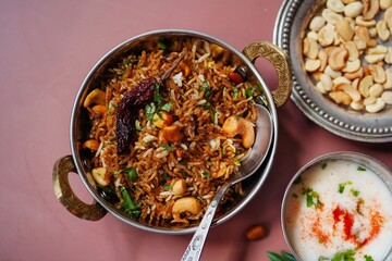 Tamarind rice or Puliyogare | Puliyodharai served with yogurt, selective focus