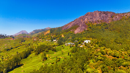 Obraz premium Stunning Drone Shot of Suryanelli Village, Munnar’s Tea Plantations & Hills