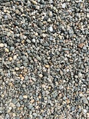 Close-up of small gray pebbles, showcasing texture. Perfect for backgrounds, nature themes, or designs highlighting natural patterns, stones, and organic elements.