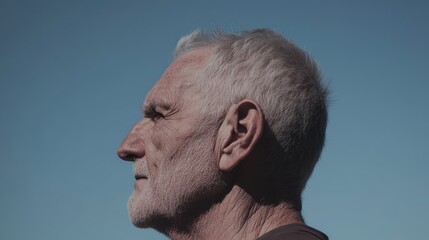 Fototapeta premium A side-profile of an aged man, every wrinkle telling a story, 