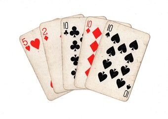 A poker hand of vintage playing cards on a white background.