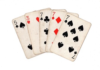 A poker hand of vintage playing cards on a white background.