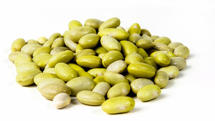 Yellow Canary beans scattered on a white surface showcasing their textures and colors