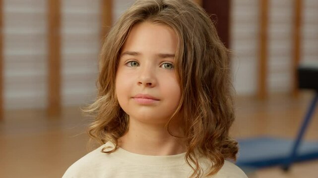 Caucasian little girl portrait gym pupil education daughter face contemplation school smiling sport student kid schoolgirl child gymnasium satisfied teenager study healthy sportswoman gymnast indoor