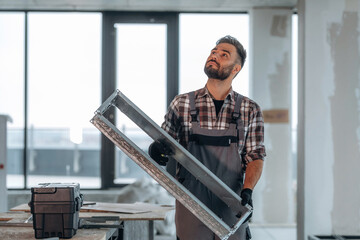 A man is renovating an unfinished room