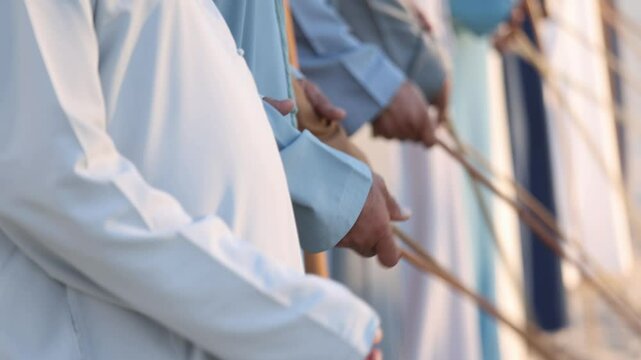 Traditional Emirati Al Ayala male dance, cultural UAE heritage, hands in frame