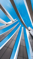 Fototapeta premium Abstract architectural shot showcasing a futuristic design of metallic slats and beams under a bright blue sky, symbolizing modernity, symmetry, and cutting-edge urban architecture.