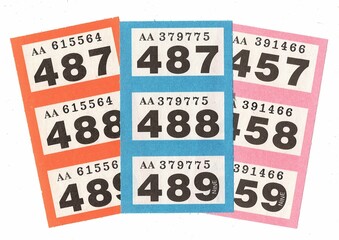 Colourful strips of vintage raffle tickets on a white background.