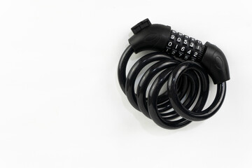 A black combination lock coiled on a white background, symbolizing security, access control, and safety measures.
