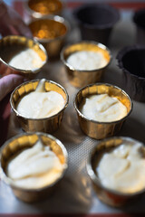 Baking process of chocolate vanilla cupcake dessert, meditation, healthy organic low sugar diet, small bakery, home baking, self care and happiness, batter in stainless steel spoon