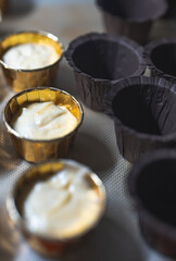 Baking process of chocolate vanilla cupcake dessert, meditation, healthy organic low sugar diet, small bakery, home baking, self care and happiness, batter in stainless steel spoon
