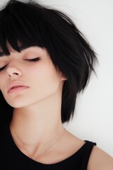 Fototapeta premium Arafed woman with black hair wearing a black top and a necklace, showcasing elegance and cultural identity.