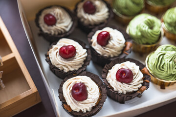 Chocolate cherry and matcha flavored cupcakes, exquisitely packaged in paper boxes, small baking business, organic low sugar cakes for parties and gatherings,cream top