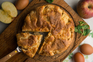 Delicious cinnamon cake with fresh apple pieces. Traditional German recipe.