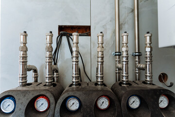 In a spacious industrial room, a wellorganized row of pipes, gauges, and equipment showcases remarkable functionality and operational precision, demonstrating efficiency