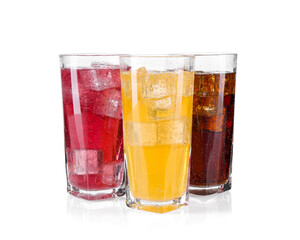 Soda water of different flavors with ice cubes in glasses isolated on white