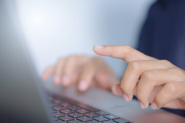 Close-up of hand tapping on laptop keyboard, digital interaction and modern technology concept