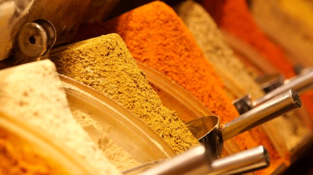 A variety of vibrant spices in bins capture the attention of shoppers