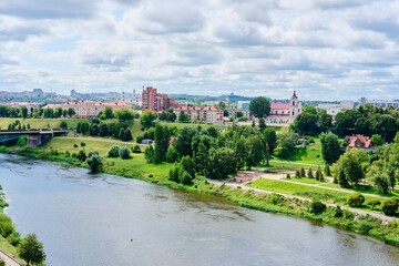 Cityscape, view from the observation deck above the river to the city blocks and green spaces along the river.