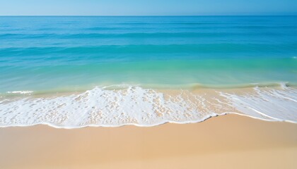 Sandy beach with calm blue ocean waves lapping the shore, perfect for a relaxing getaway, evoking peace and serenity