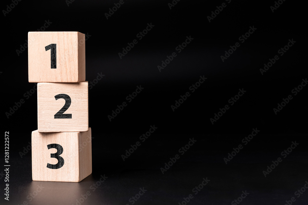 Poster Stack of wooden cubes with 1,2,3 numbers set on black background with copy space, step-by-step process