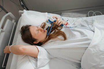 Woman in Labor Using Gas and Air for Pain Relief in Hospital