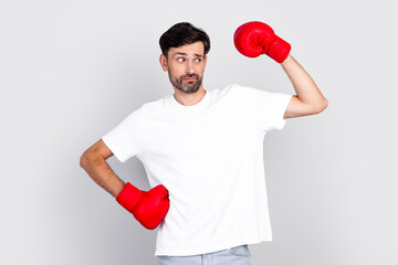 Portrait of a Young Man Posing with Red Boxing Gloves Exhibiting Playful Expressions and Gestures...