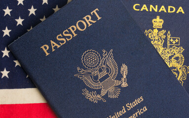 US and Canadian passports with US flag in the background
