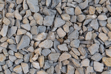 A collection of various paving stones arranged for pathway construction, showcasing different shapes, sizes, and textures ideal for garden or driveway design