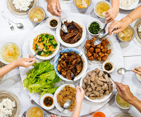 A Chinese New Year Eve Family Dinner with A Table Full of Chinese Traditional Dishes