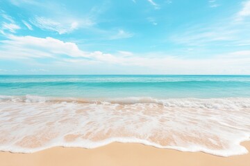 soft pastel waves gently roll over sandy beach creating serene and calming scene with clear blue skies overhead providing
