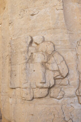 Archaeological relief on a light sandstone wall