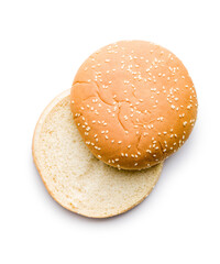 Empty burger bun with sesame seeds isolated on white background.