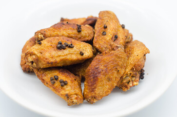 Crispy fried chicken wings on a white plate