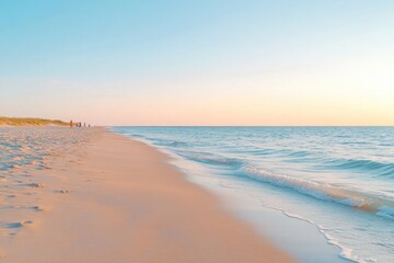 Obraz premium golden hour on serene beach with calm waves and soft sand underfoot