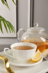 Refreshing green tea and slice of lemon on tray, closeup