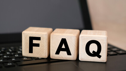 FAQ - text on wooden cubes, on wooden background