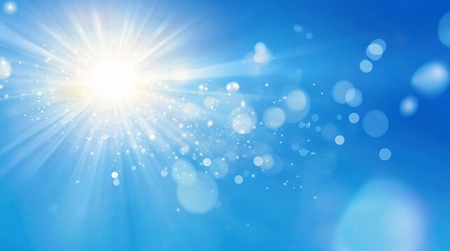 Bright sun rays in clear blue sky with light bokeh effects and lens flares. Natural summer day background with sunburst. Outdoor fresh morning atmosphere with copy space