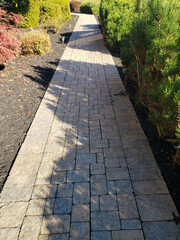 sidewalk paved with granite tiles in an urban environment.