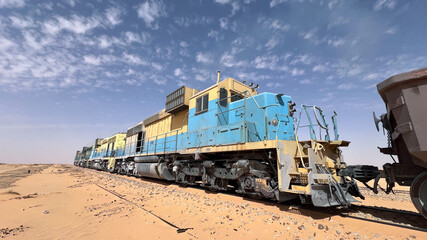 A set of 4 powerful diesel locomotives pull the train that crosses the Mauritanian Sahara desert between Zouerate and Nouadhibou. It is one of the heaviest trains in the world