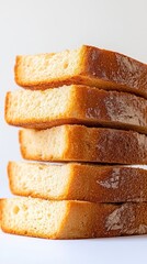 Stack of Freshly Baked Bread Slices on White Backdrop Close Up Capturing Golden Crust and Soft Interior in Simple Still Life Food Photography