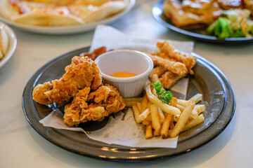 Fast food package contains fried chicken, french fries, and sausages. Fast food ready to eat in restaurants