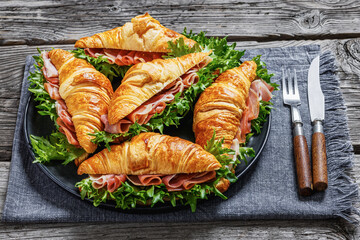 croissant sandwiches with ham and lettuce on plate