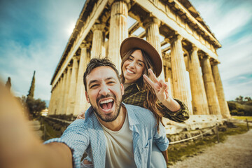Happy couple in love visiting the Acropolis of Athens, Greece - Boyfriend and girlfriend having fun...