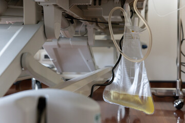 urine bag under patient modern bed in hospital room