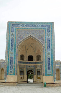 Impressive entrance (Iwan, Pishtaq)  of Kalyan Mosque part of Po-i-Kalyan Complex with arch and decoration of ceramic mosaic, calligraphy, and geometric ornaments in Bukhara , Uzbekistan, Asia